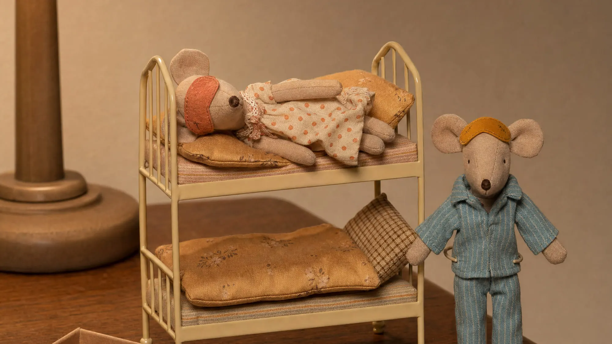 Maileg mum and dad mice at bedtime by the wheat bunk bed, eye masks on, one lamp lit in a real bedroom