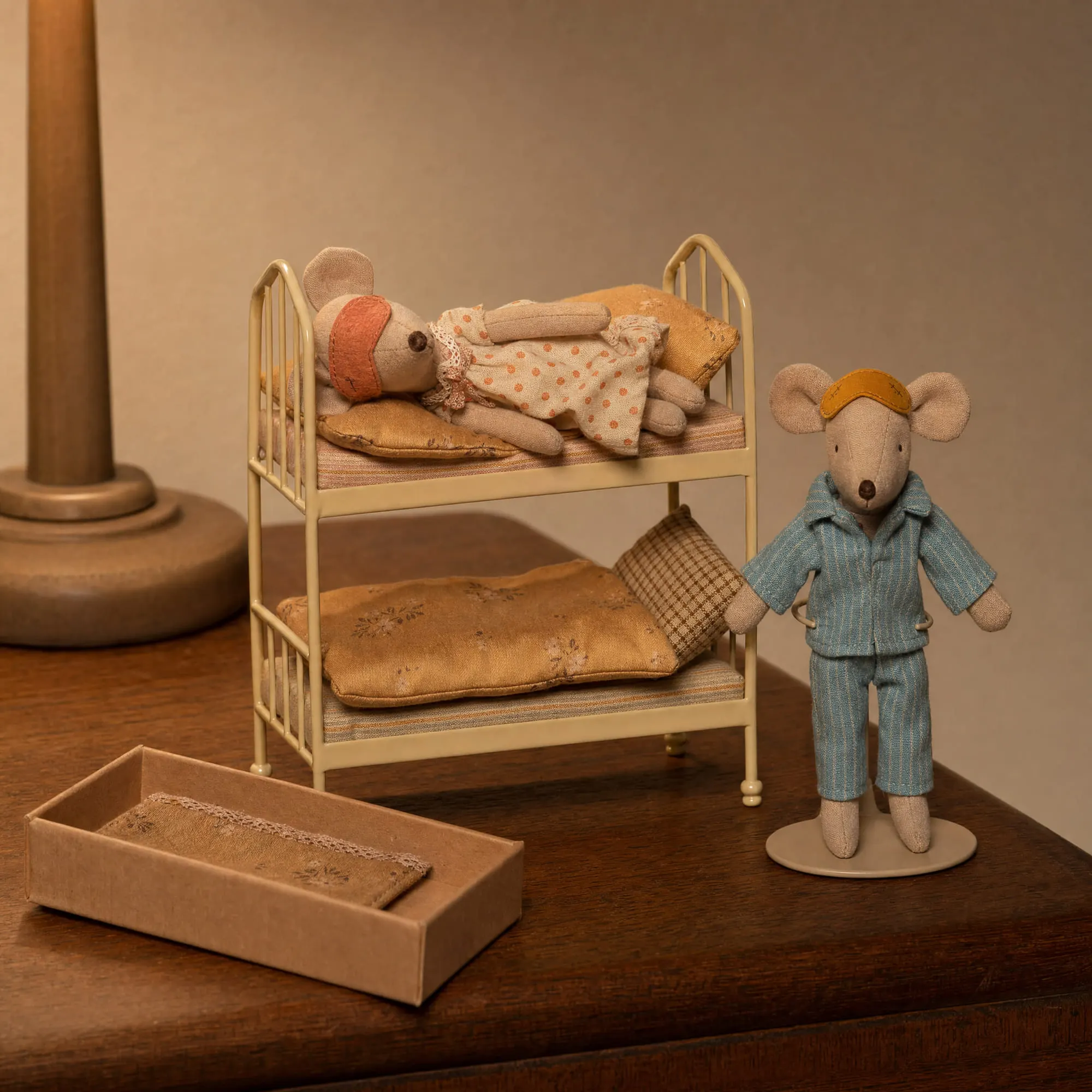Maileg mouse display stand holding dad mouse beside the wheat bunk bed with mum mouse and the cigar box