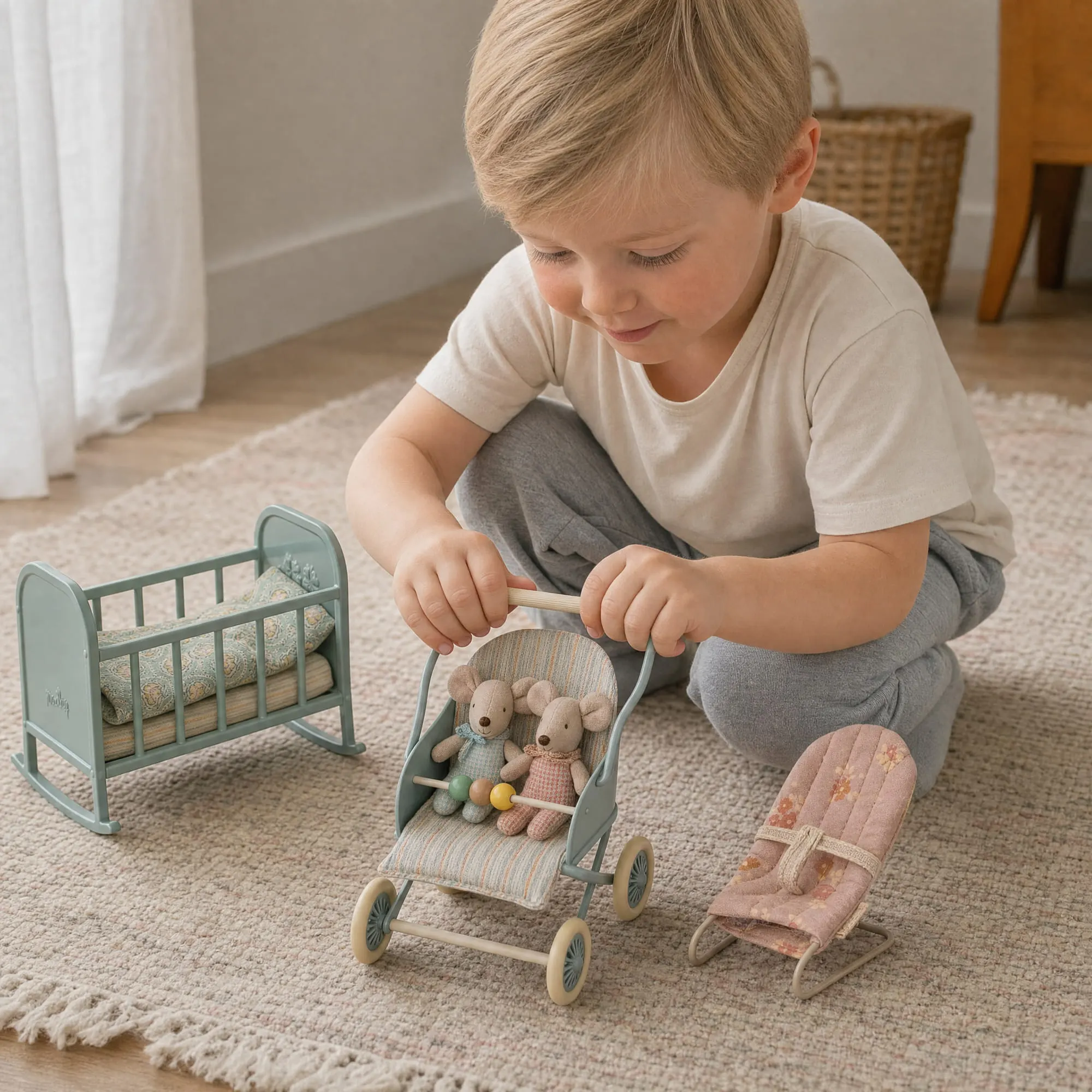 Maileg baby mouse stroller pushed by a boy with the baby twin mice, sage cradle and babysitter chair